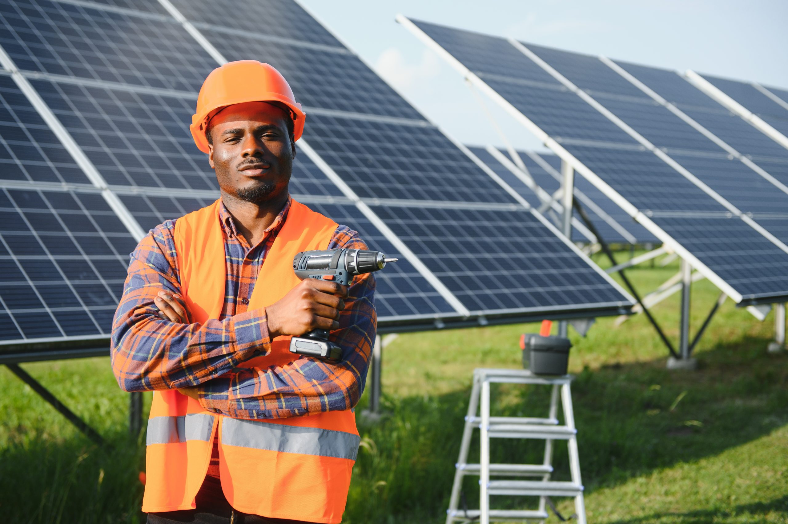Services 15 African American electrician worker installs solar panels. Green energy.