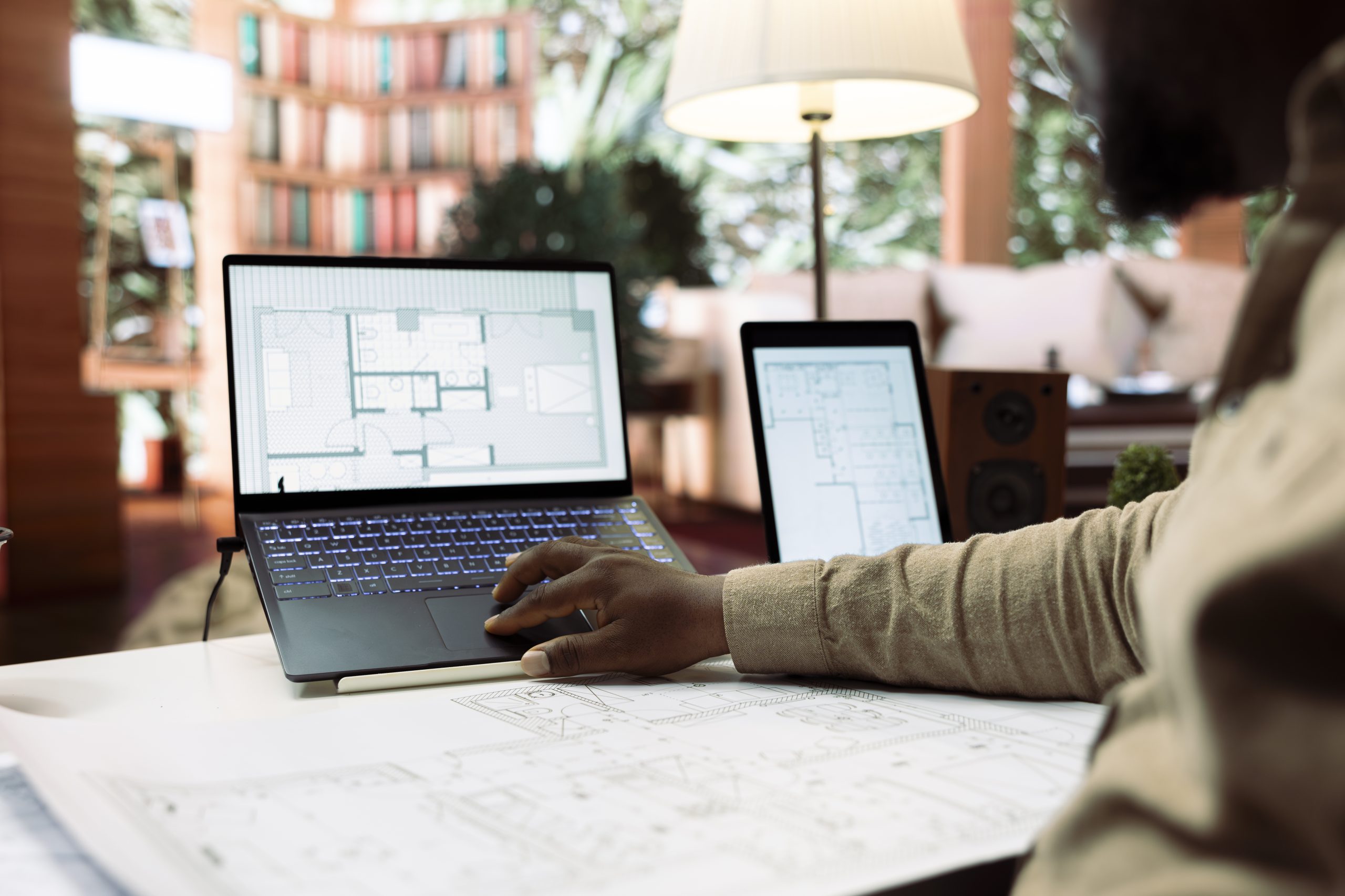 Services 9 Businessman using digital tools to draft and plan office spaces to relocate, reviewing blueprints for a strategic and professional layout. Entrepreneur searching for new creative workspaces.