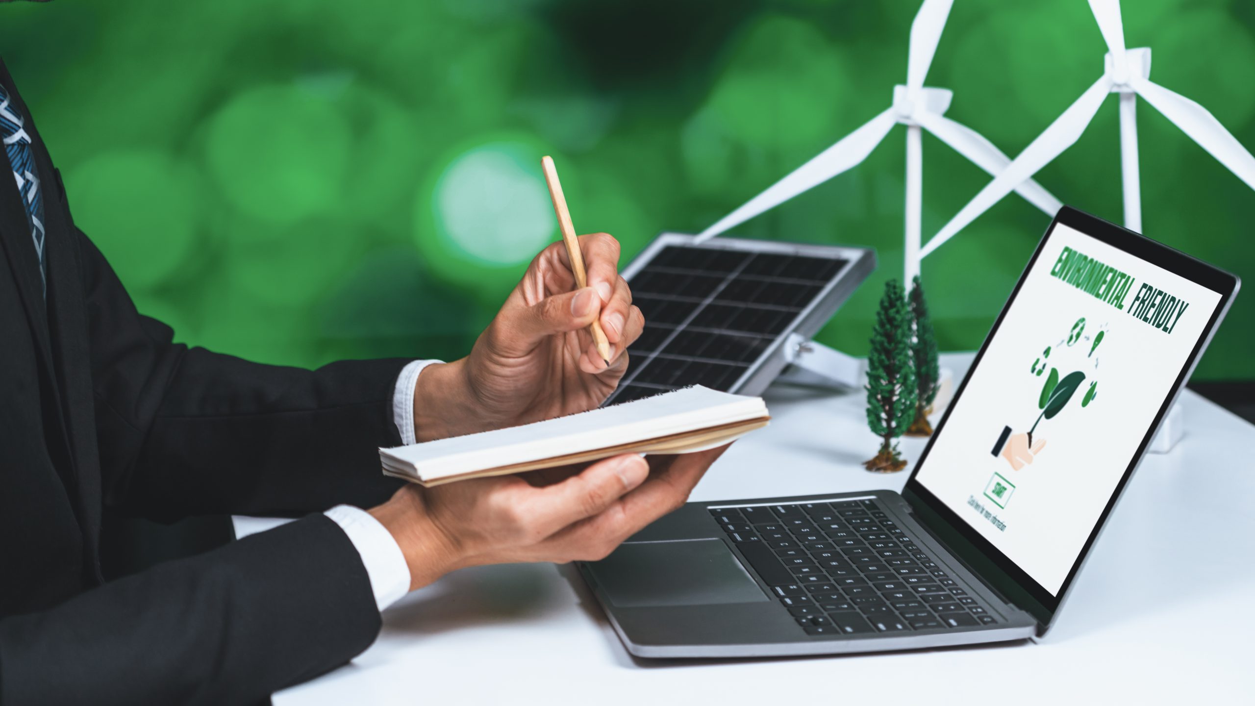 Services 1 Businessman working in office developing plan or project on eco-friendly alternative energy with solar cell technology display on computer screen for greener environment as apart of CSR effort. Gyre