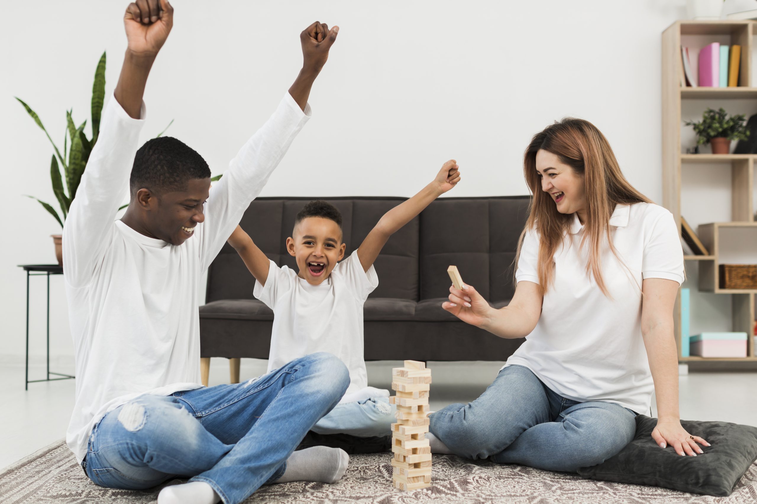 Services 24 little-boy-playing-game-with-his-parents-indoors