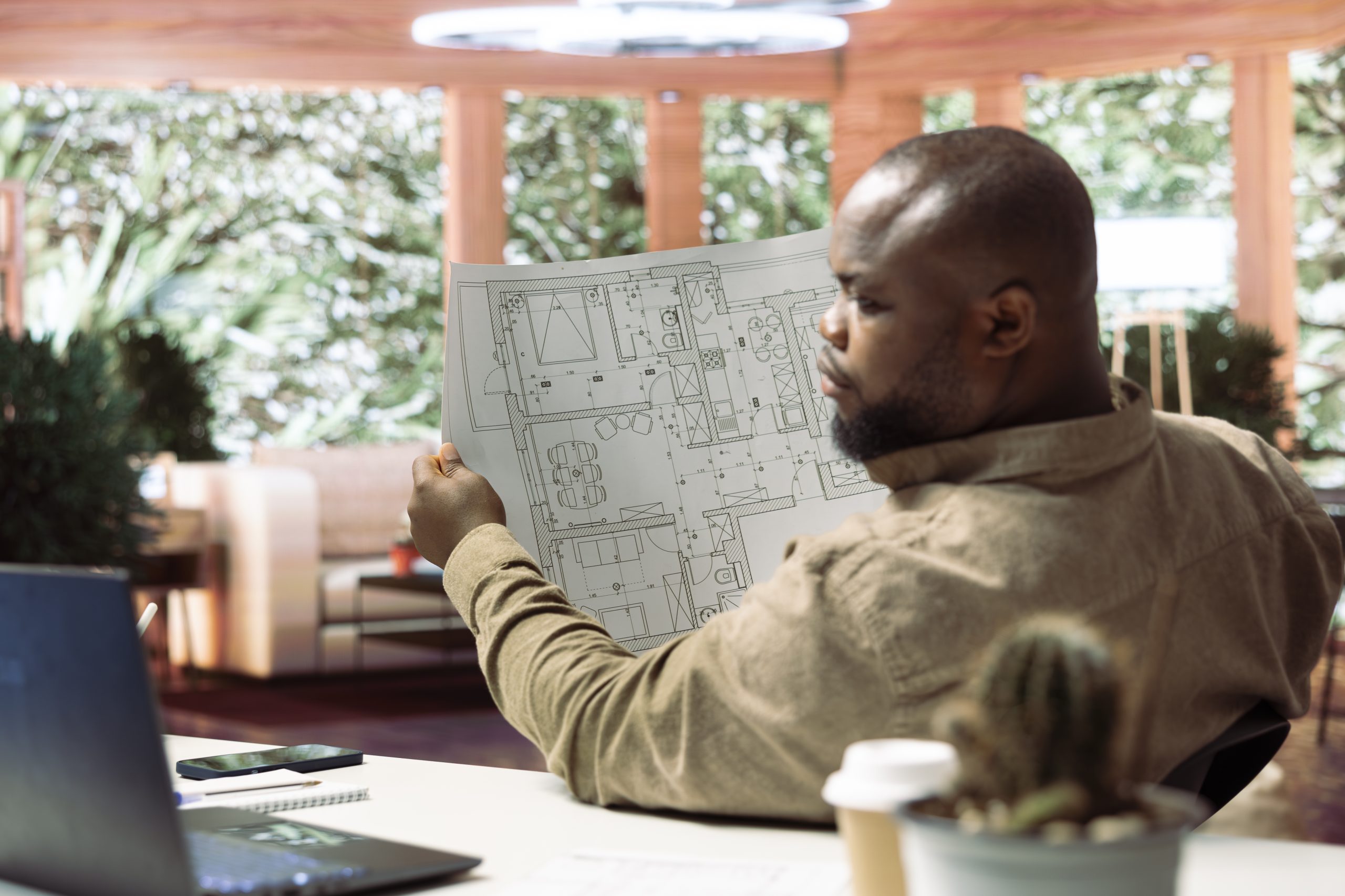 Services 12 Small business owner analyzing architectural sketches and planning office spaces